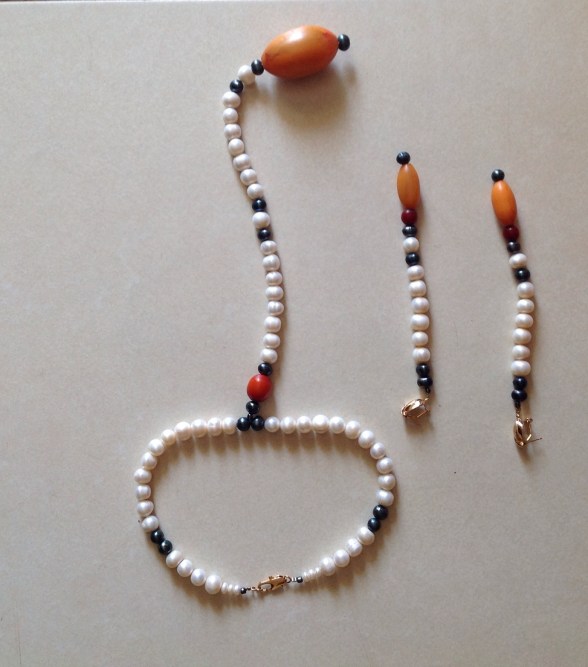 IJE- STYLE IS INNATE- necklace designed by Eeefy Pearl is from the luxurious river Benue, river Niger and sea of Lagos, Nigeria Amber is found in Bauchi State, Nigeria HEALING PROPERTIES:  Pearls is known for it's calming properties...set to aide purity, charity, integrity, truth and loyalty in its wearer. Amber aides memory loss, purifies the body, elevates headaches and bone and hart problems.. Known for its stress relieving and calming properties