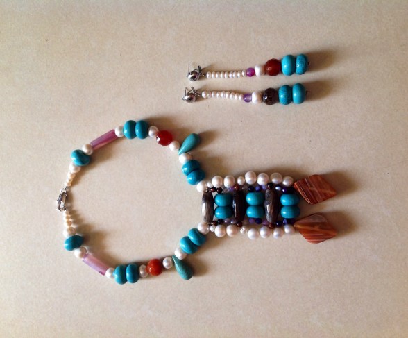 EKWI-   STYLE IS INNATE-  handcrafted necklace designed by Eeefy Pearl is from the luxurious river Benue, river Niger and sea of Lagos, Nigeria Turquoise is found in Bauchi State  Agate Stone is From the luxurious climes of the PLATEU State of Nigeria  HEALING PROPERTIES: Pearls is known for it's calming properties...set to aide purity, charity, integrity, truth and loyalty in its wearer.  Turquoise is a healing and balancing stone steeped in love and tradition.  Agate is a stone of strength. Increases energy, enhances creativity, give courage, self confidence, emotional strength and dispels fear. 