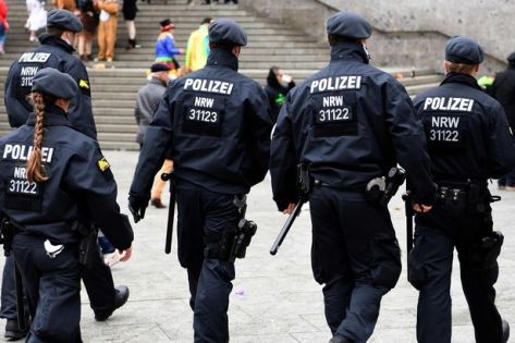 police-walks-past-revellers-celebrating