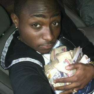Image result for davido carrying money